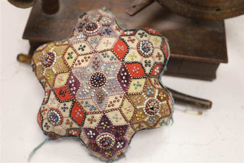 A Victorian bead and patchwork star-shaped pin cushion by M E Ashmore 1884 and two other items, W 20cm (cushion)